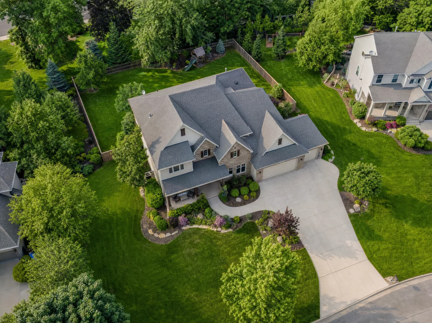 Aerial drone photo of a suburban house and yard, daytime, clean composition